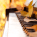 Piano with autumn leaves falling onto the keys